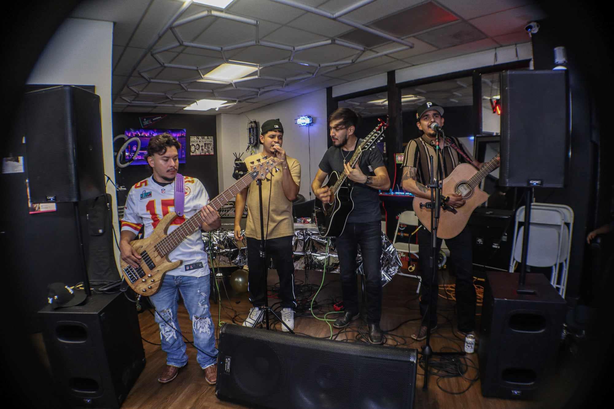 Live band performing on stage during a past KC Fade Wars barber battle event, with attendees enjoying music and entertainment.